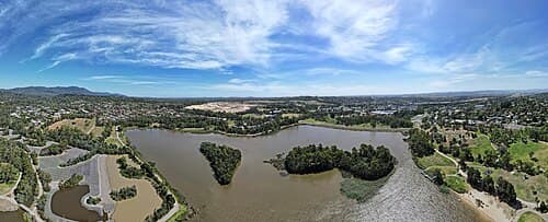 A lake and its surrounding land seen from the air